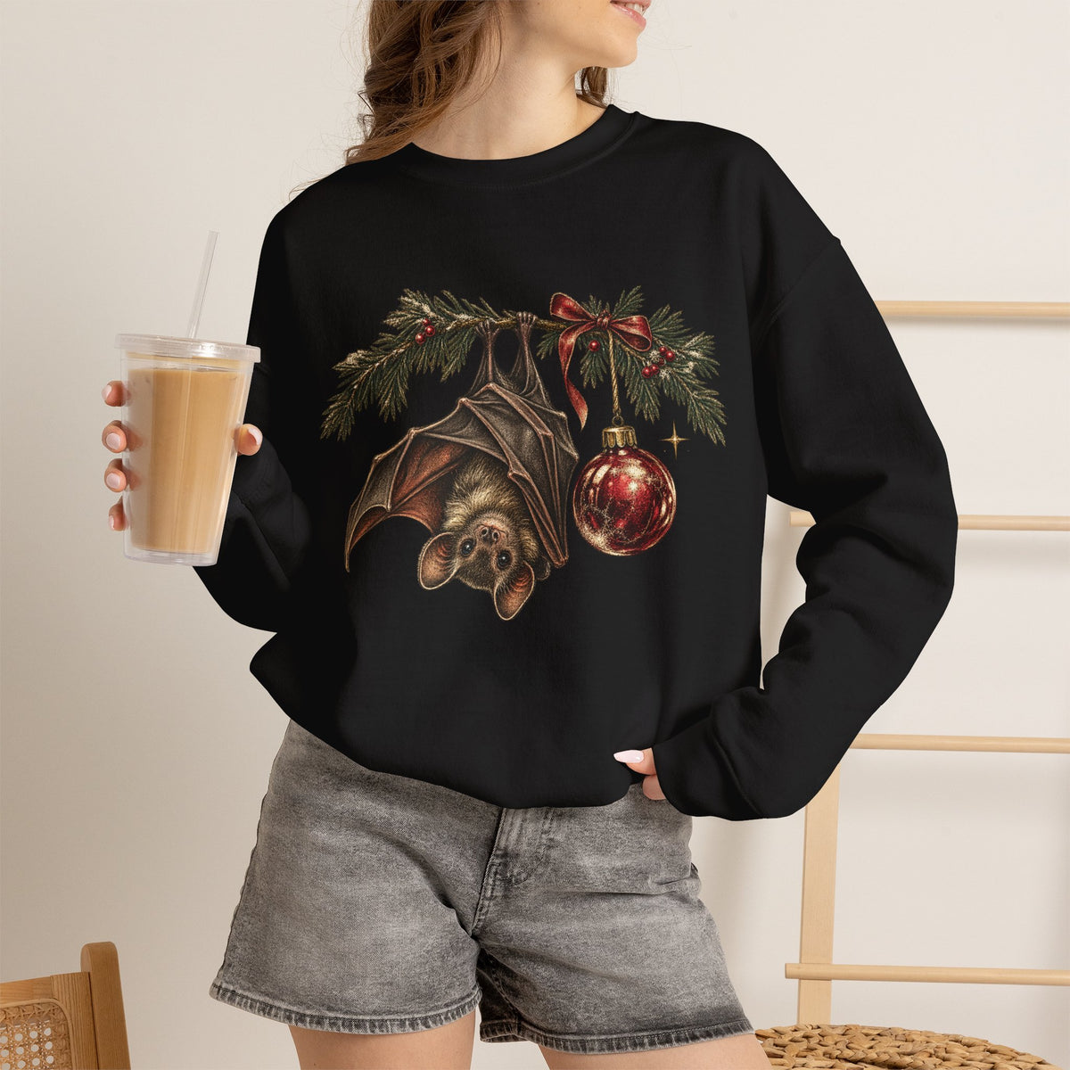Gothic Christmas bat sweatshirt with a vintage bat, evergreen boughs and a red ornament
