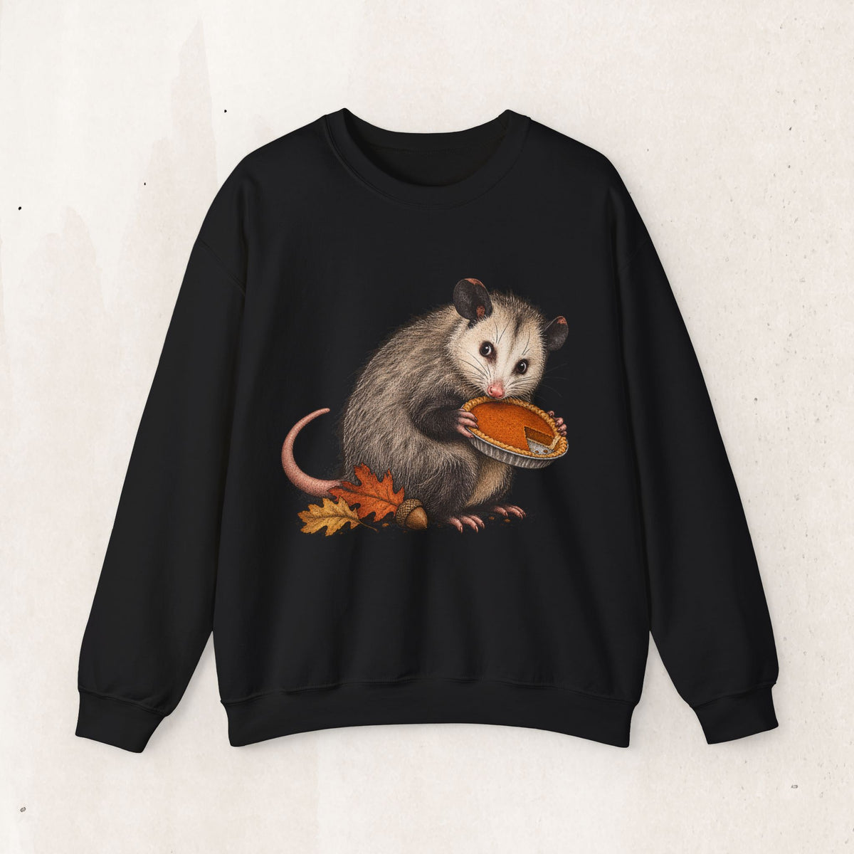 Opossum Thanksgiving sweatshirt with a cute possum hugging an orange pumpkin in autumn leaves