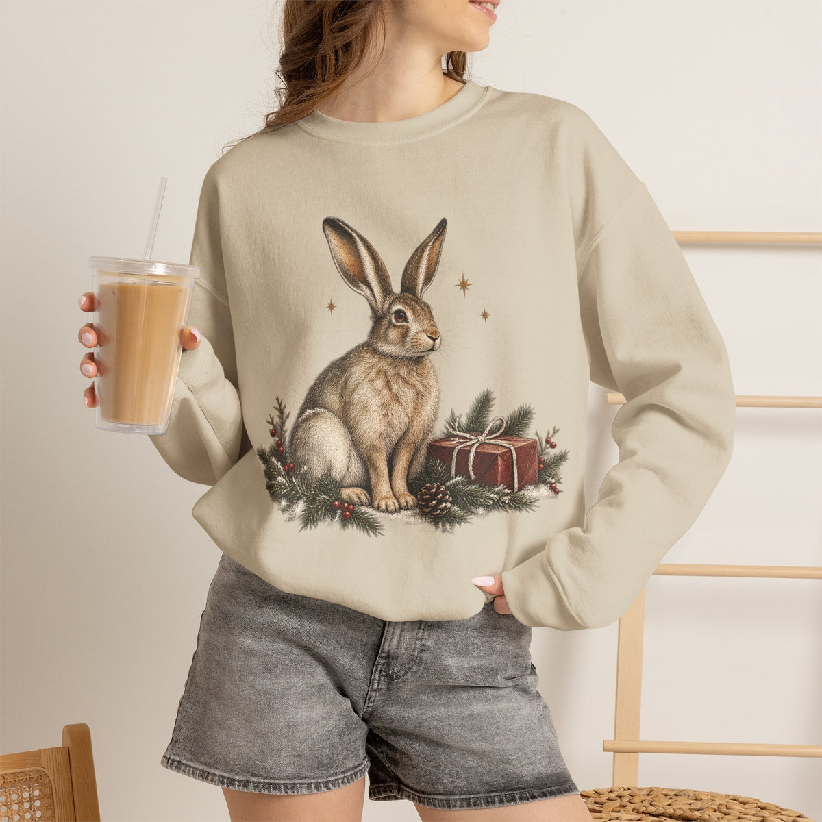 Christmas bunny sweatshirt with a vintage woodland rabbit, evergreen branches, stars and gifts
