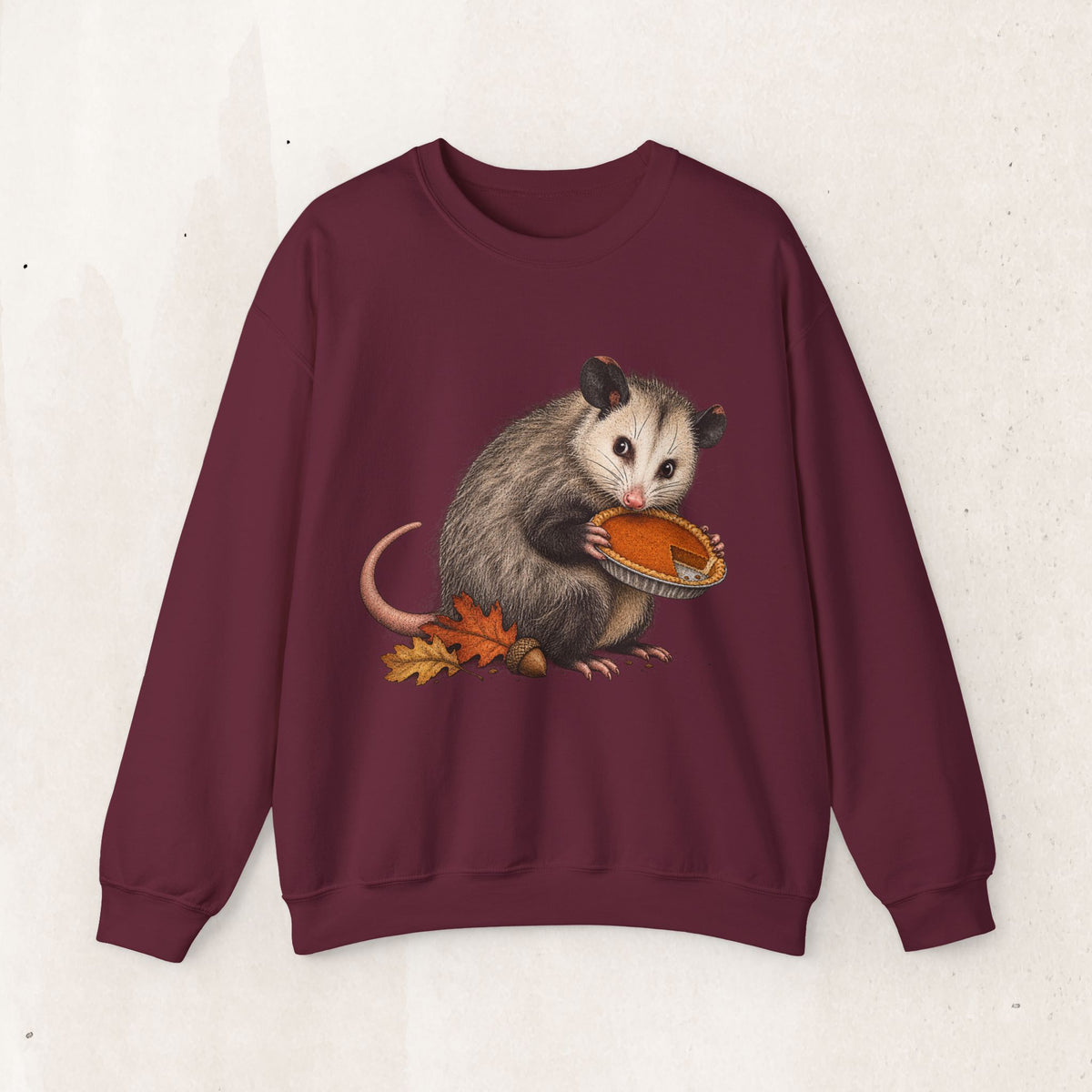 Opossum Thanksgiving sweatshirt with a cute possum hugging an orange pumpkin in autumn leaves