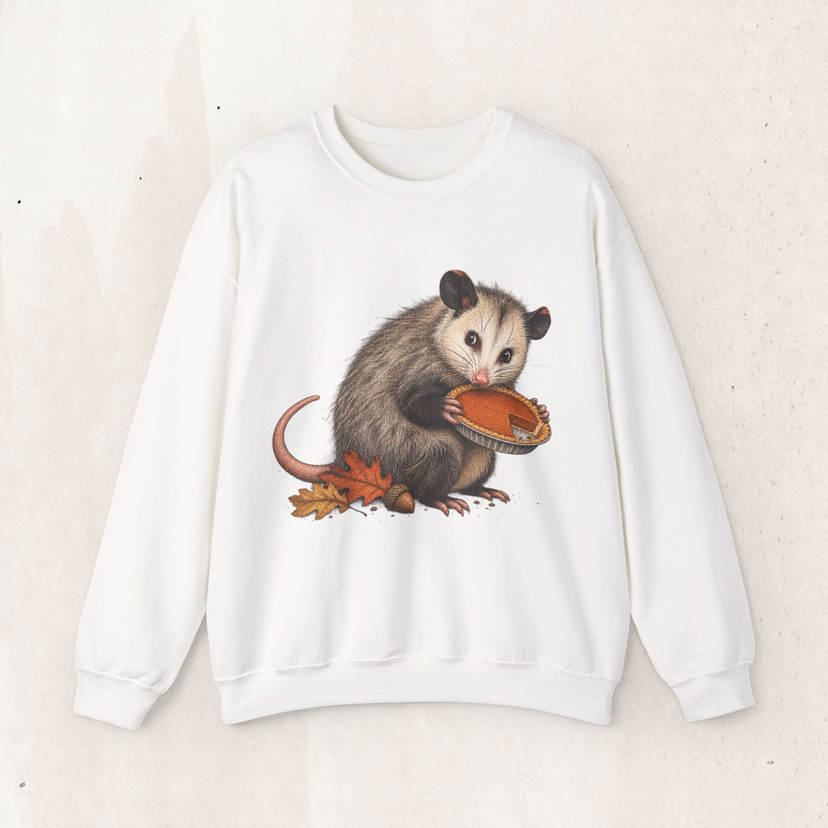 Opossum Thanksgiving sweatshirt with a cute possum hugging an orange pumpkin in autumn leaves