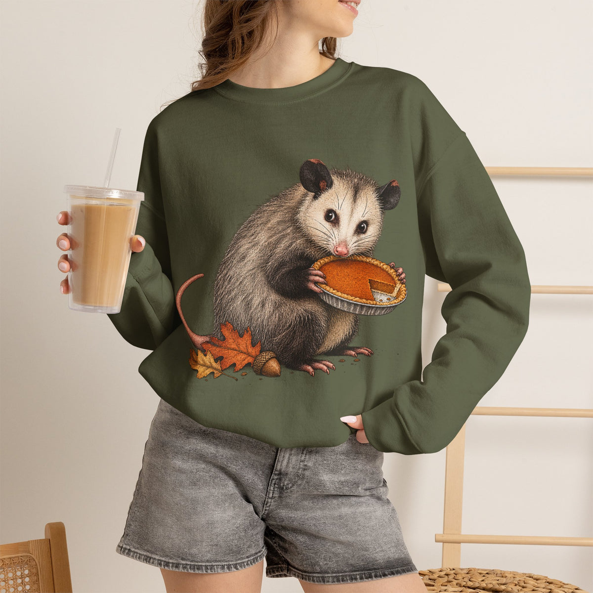 Opossum Thanksgiving sweatshirt with a cute possum hugging an orange pumpkin in autumn leaves