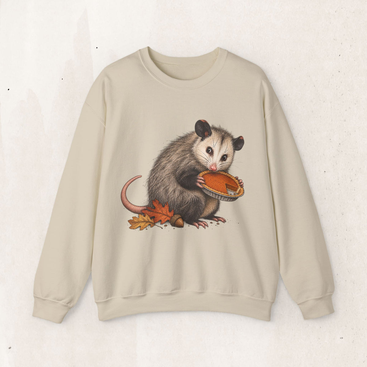Opossum Thanksgiving sweatshirt with a cute possum hugging an orange pumpkin in autumn leaves
