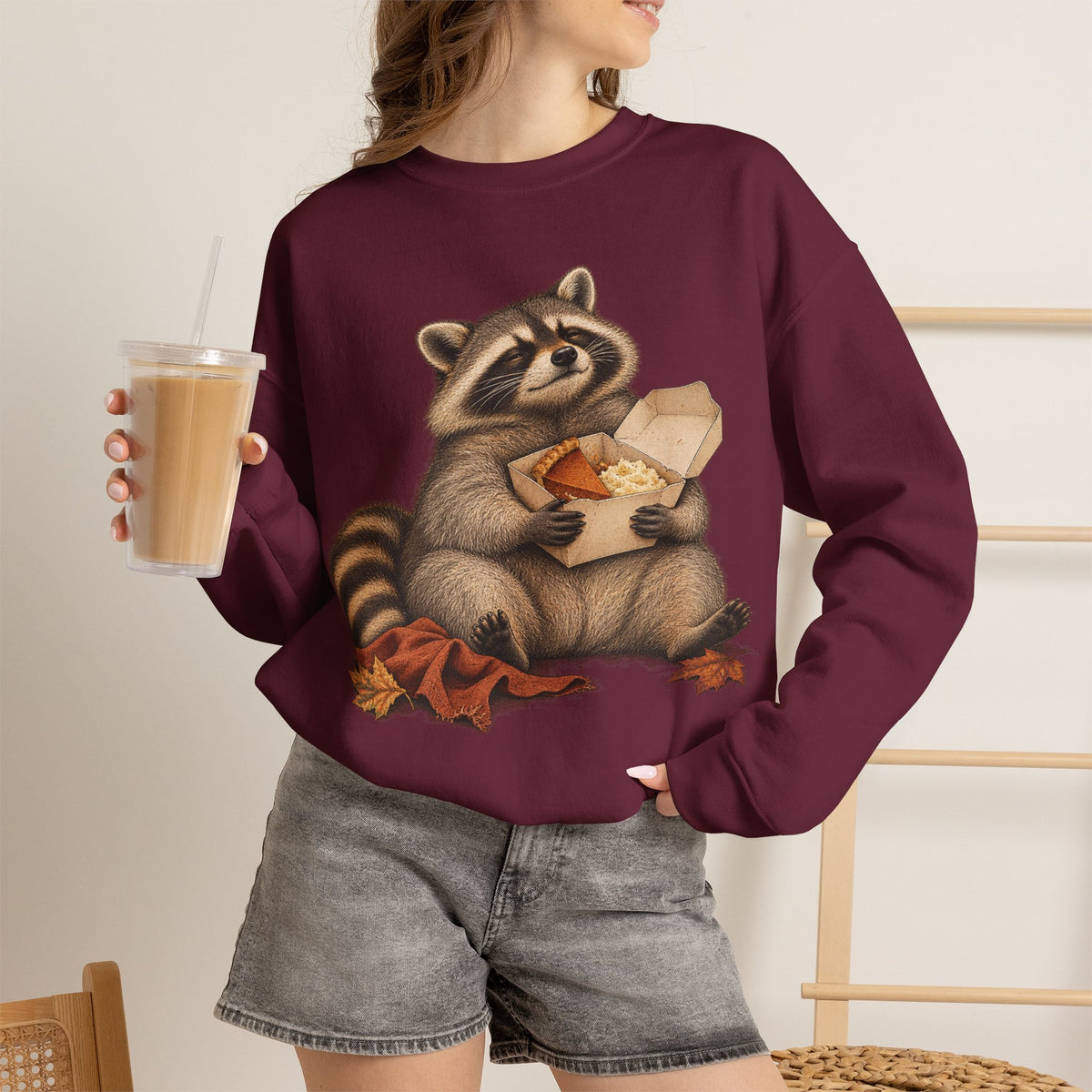 Cute raccoon fall crewneck sweatshirt with a vintage raccoon holding a mug in autumn leaves