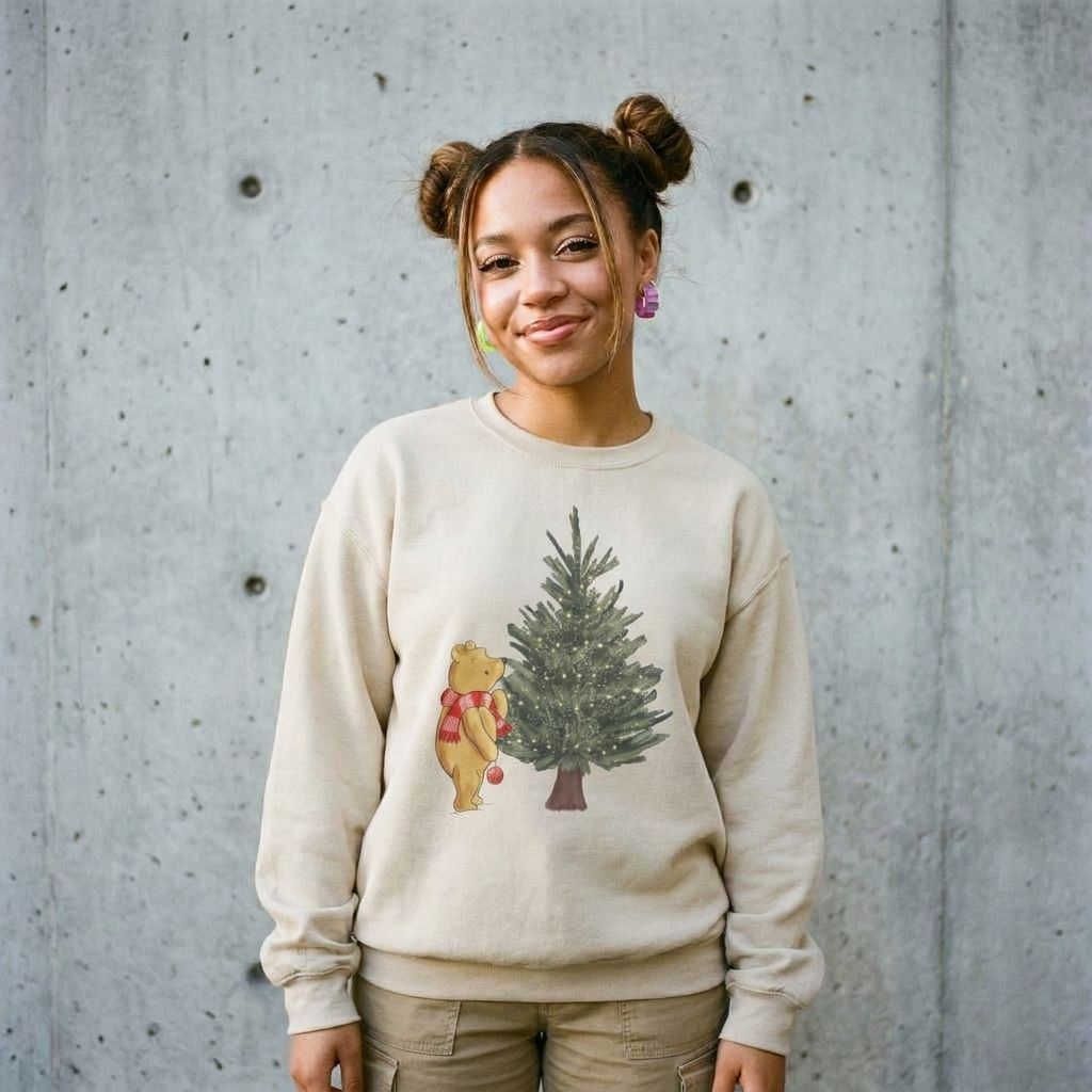 Model wearing Christmas Winnie the Pooh and Christmas Tree Sweatshirt against a cement wall