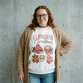 Model wearing All Booked for Christmas Sweatshirt against a cement wall