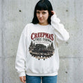 Model wearing Creepmas Tree Farm Christmas Sweatshirt against a cement wall