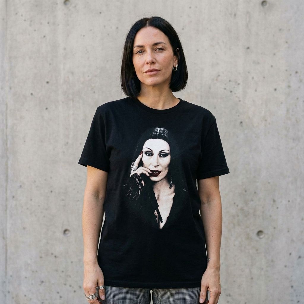 Model wearing Morticia Addams Portrait Tee against a cement wall