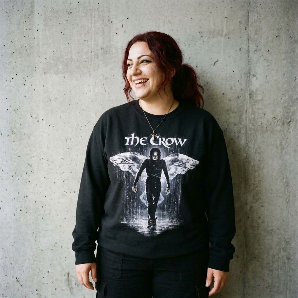 Model wearing The Crow Graphic Crewneck Sweatshirt against a cement wall