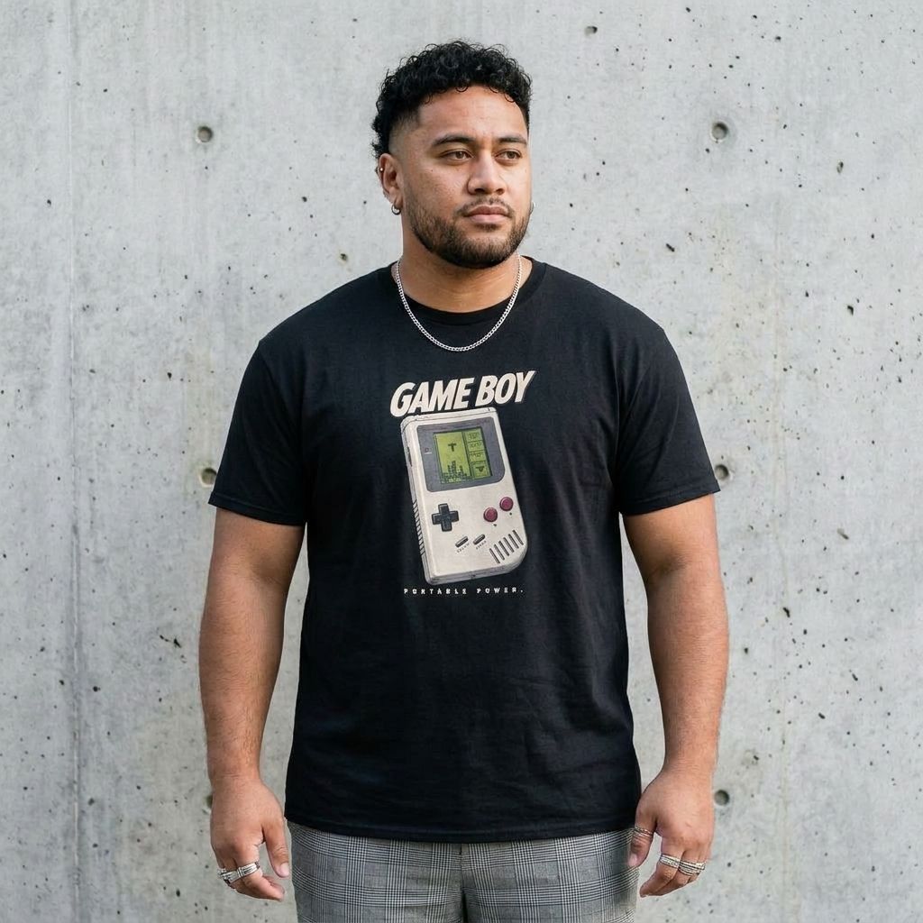 Model wearing Retro Game Console Graphic Tee – Vintage Gamer Shirt against a cement wall