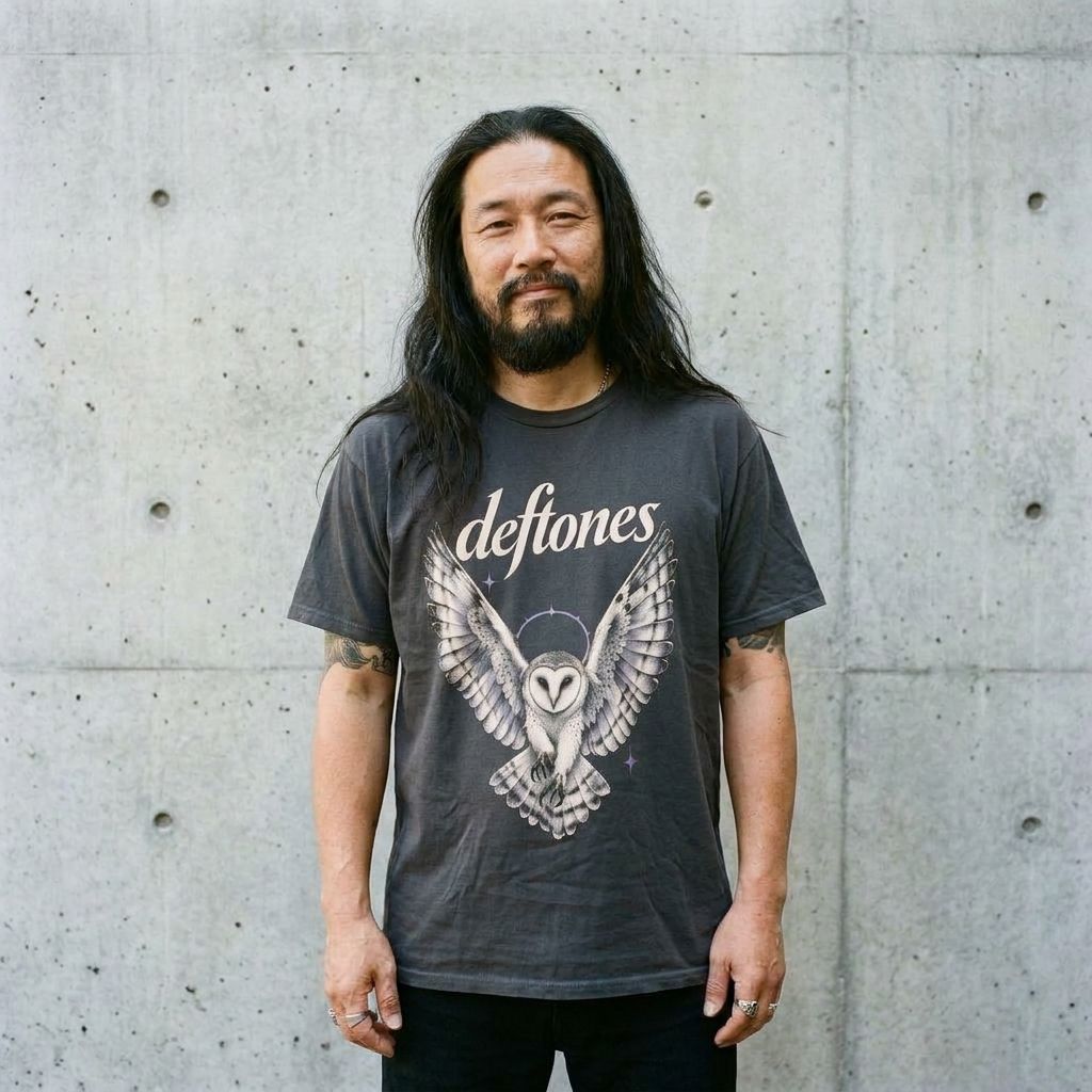 Model wearing Deftones Graphic Tee – Vintage Wings Band Shirt against a cement wall