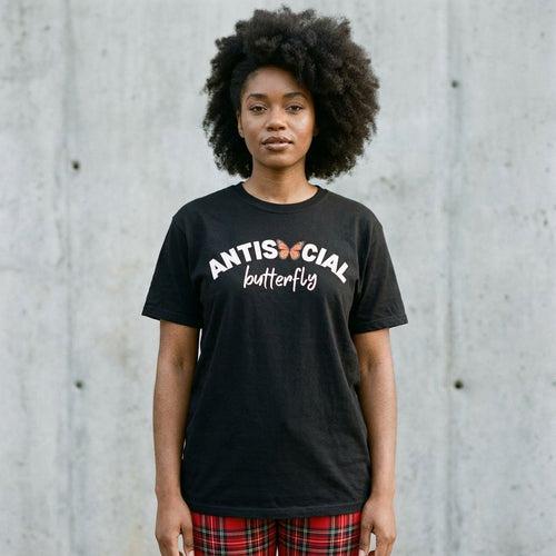 Model wearing Antisocial Butterfly Tee – Funny Introvert Graphic Shirt against a cement wall