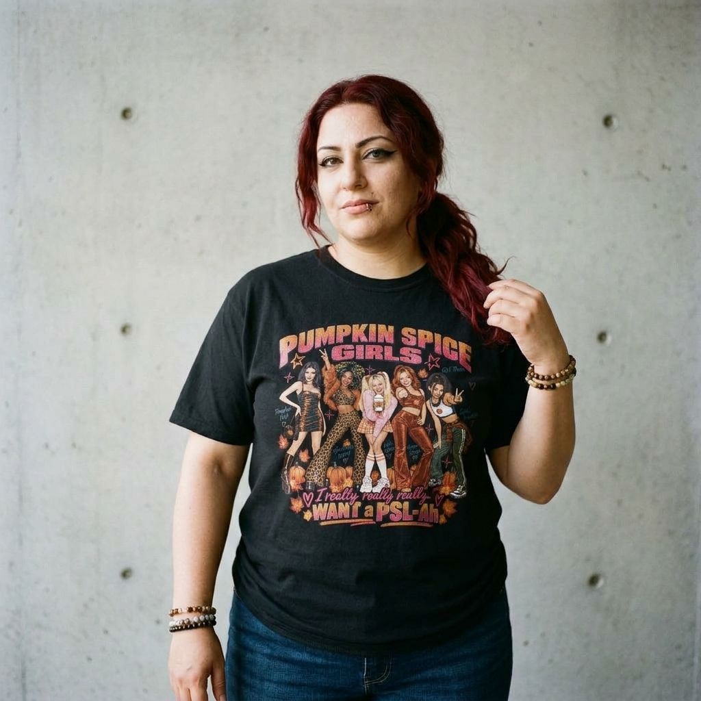 Model wearing Pumpkin Spice Girl Graphic Tee against a cement wall