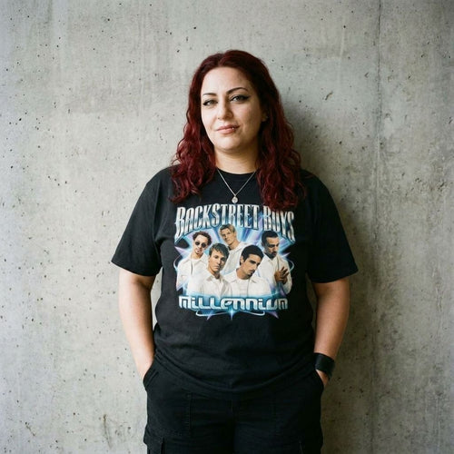 Model wearing Backstreet Boys 'Millennium' Pop Tour Tee against a cement wall