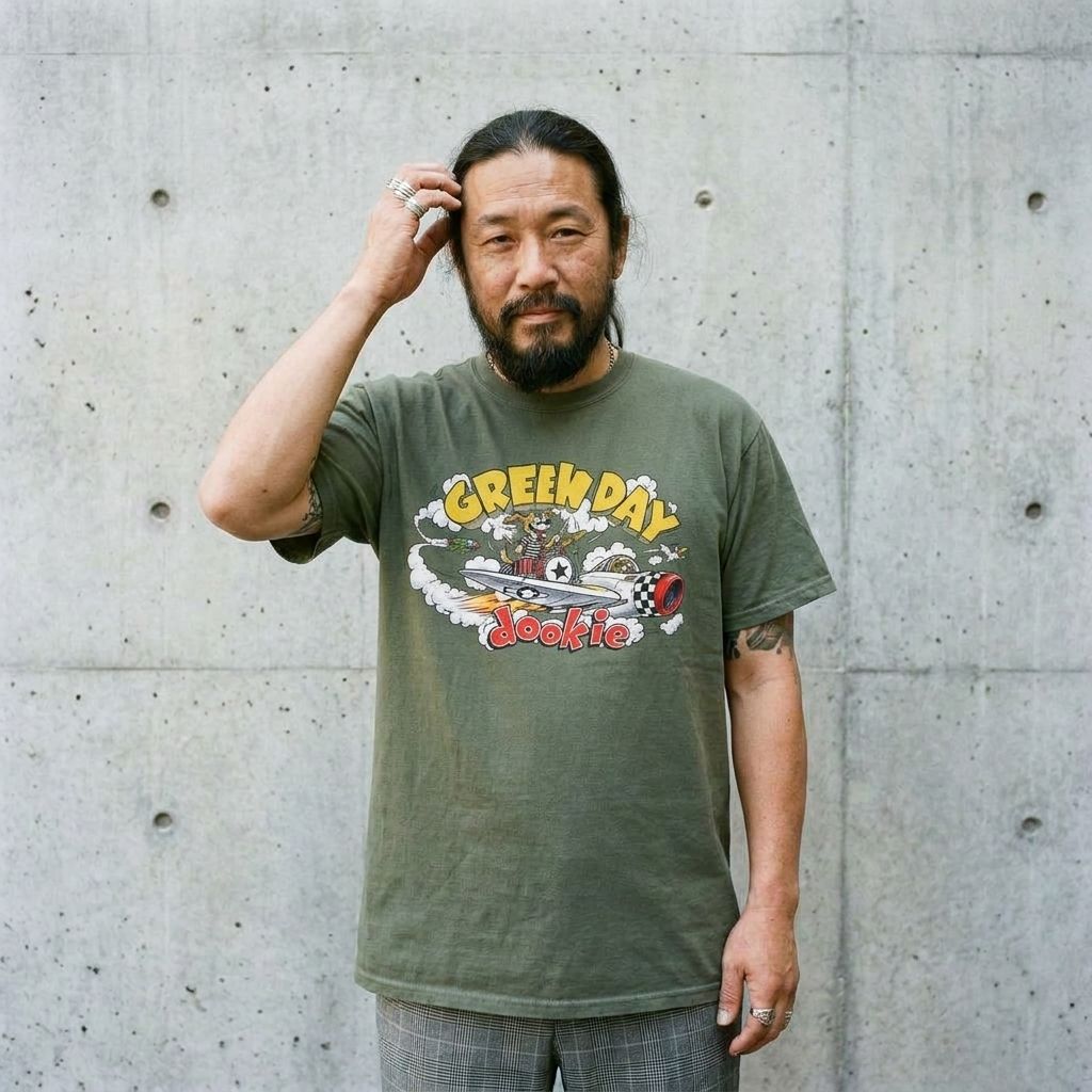 Model wearing Green Day Dookie Tee – Vintage 90s Punk Band Shirt against a cement wall