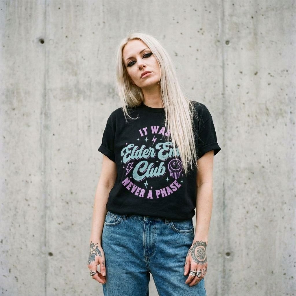 Model wearing Elder Emo Club Graphic Tee against a cement wall