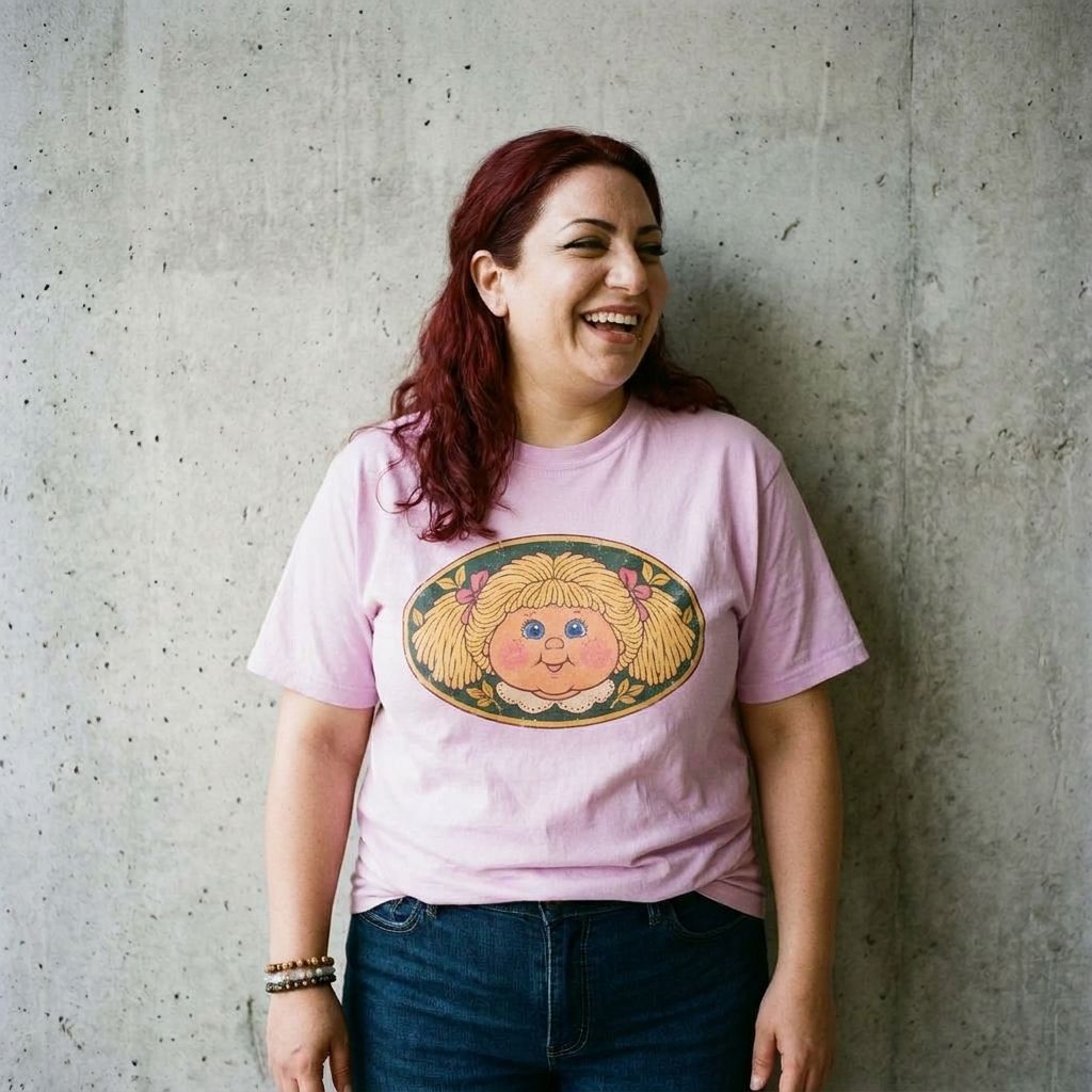 Model wearing Cabbage Patch Kids Graphic Tee against a cement wall