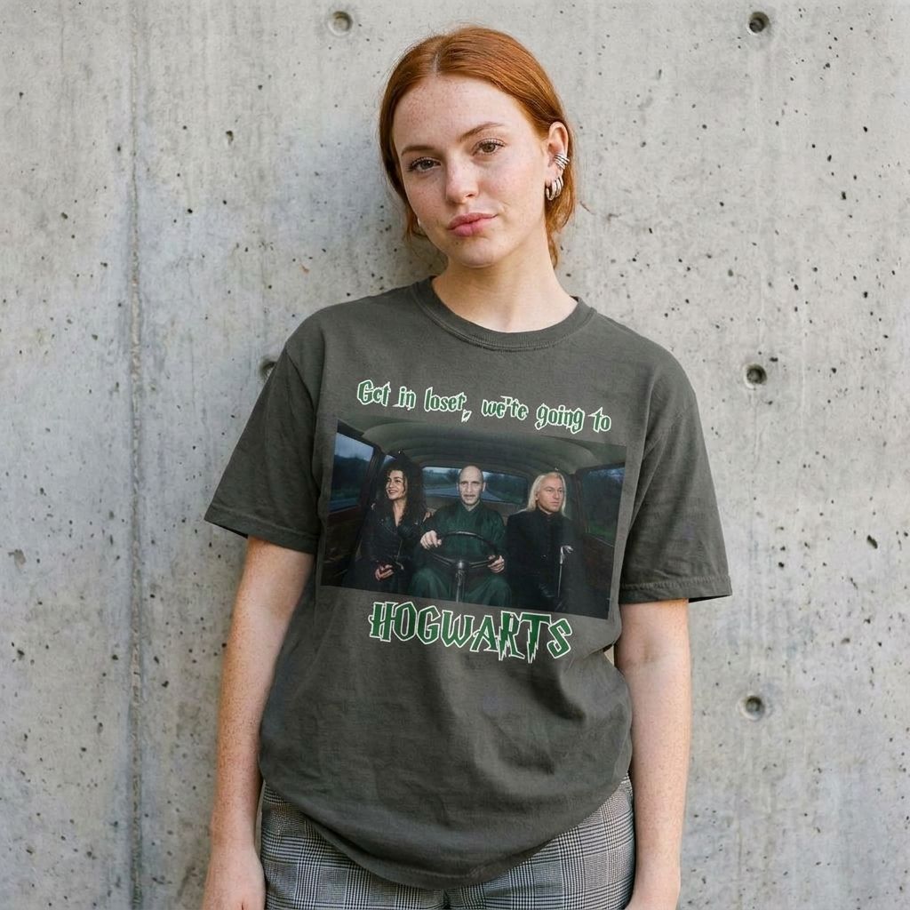 Model wearing Get in Loser We're Going to Hogwarts Tee – Wizard Graphic against a cement wall