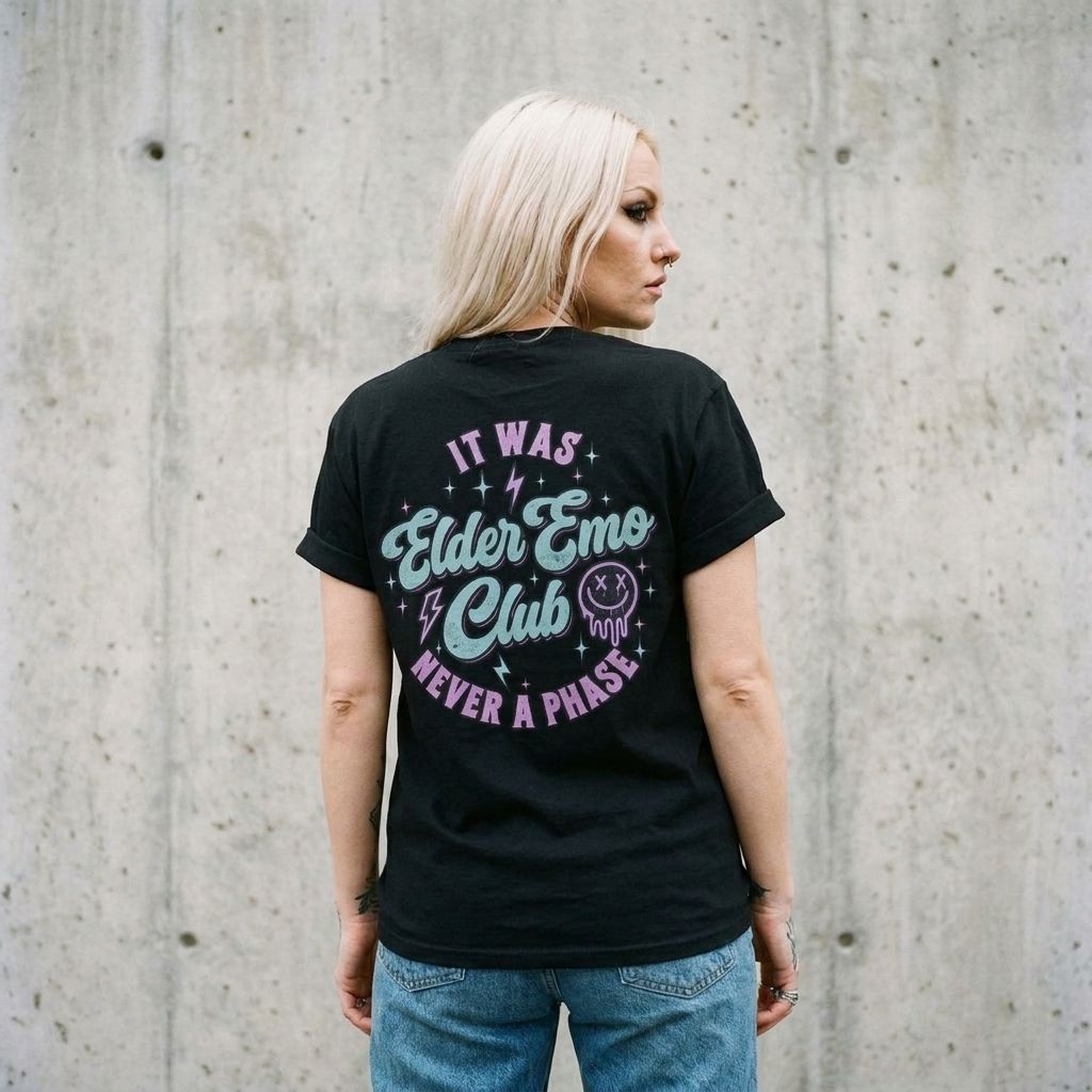 Back view of model wearing Elder Emo Club Graphic Tee against a cement wall