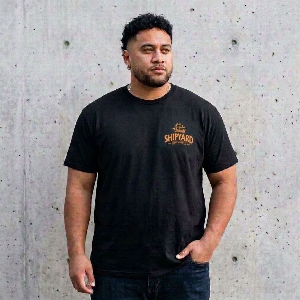 Model wearing Pumpkinhead Ale Tee against a cement wall