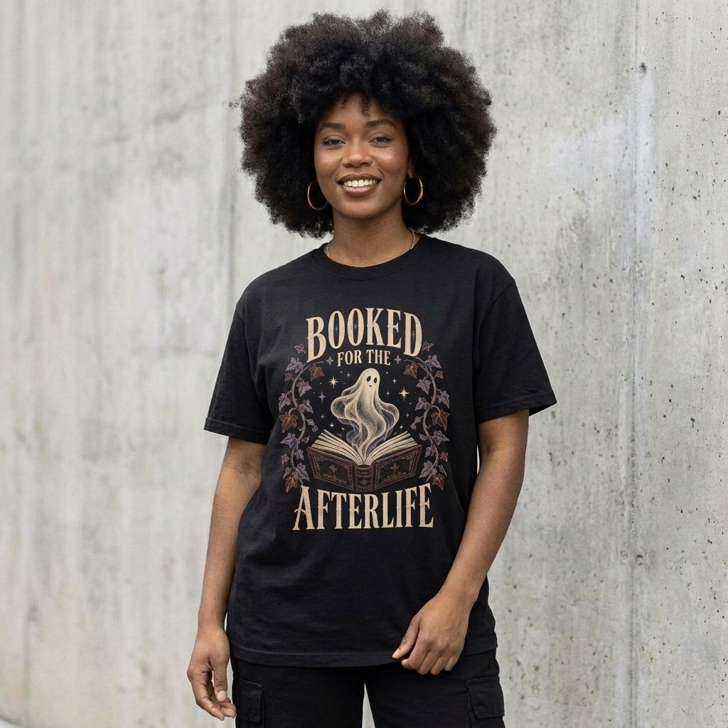 Model wearing Booked for the Afterlife Tee against a cement wall