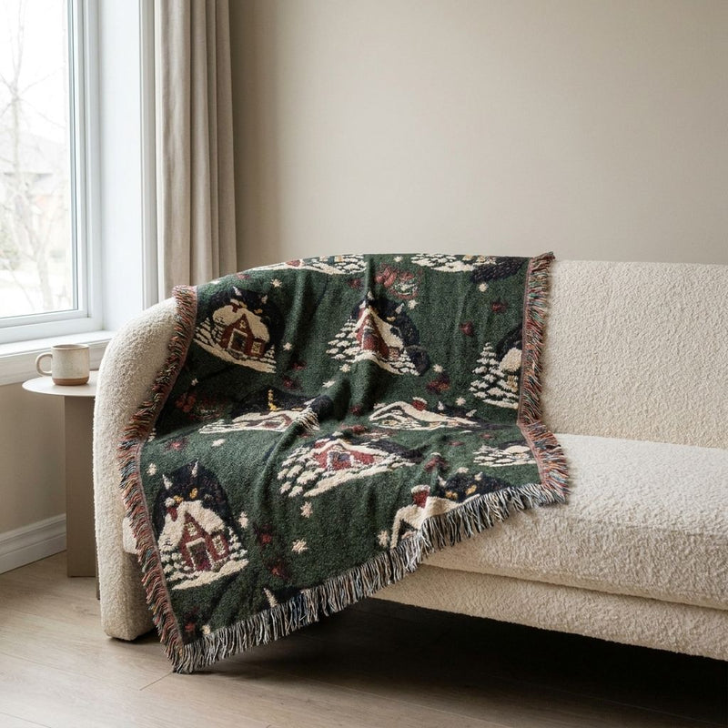 Christmas Yule Cat Woven Blanket draped over a sofa in a living room
