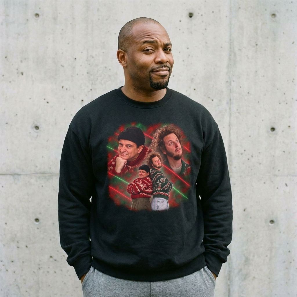 Man wearing the Harry and Marv Home Alone glamour portrait Christmas sweatshirt against a cement wall