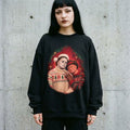 Woman wearing the Freddy and Michael 80s glamour portrait horror Christmas sweatshirt against a cement wall