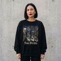 Woman wearing the Frau Perchta Christmas sweatshirt against a cement wall