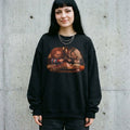 Model wearing the Chucky & Tiffany Thanksgiving wishbone sweatshirt in Black against a cement wall