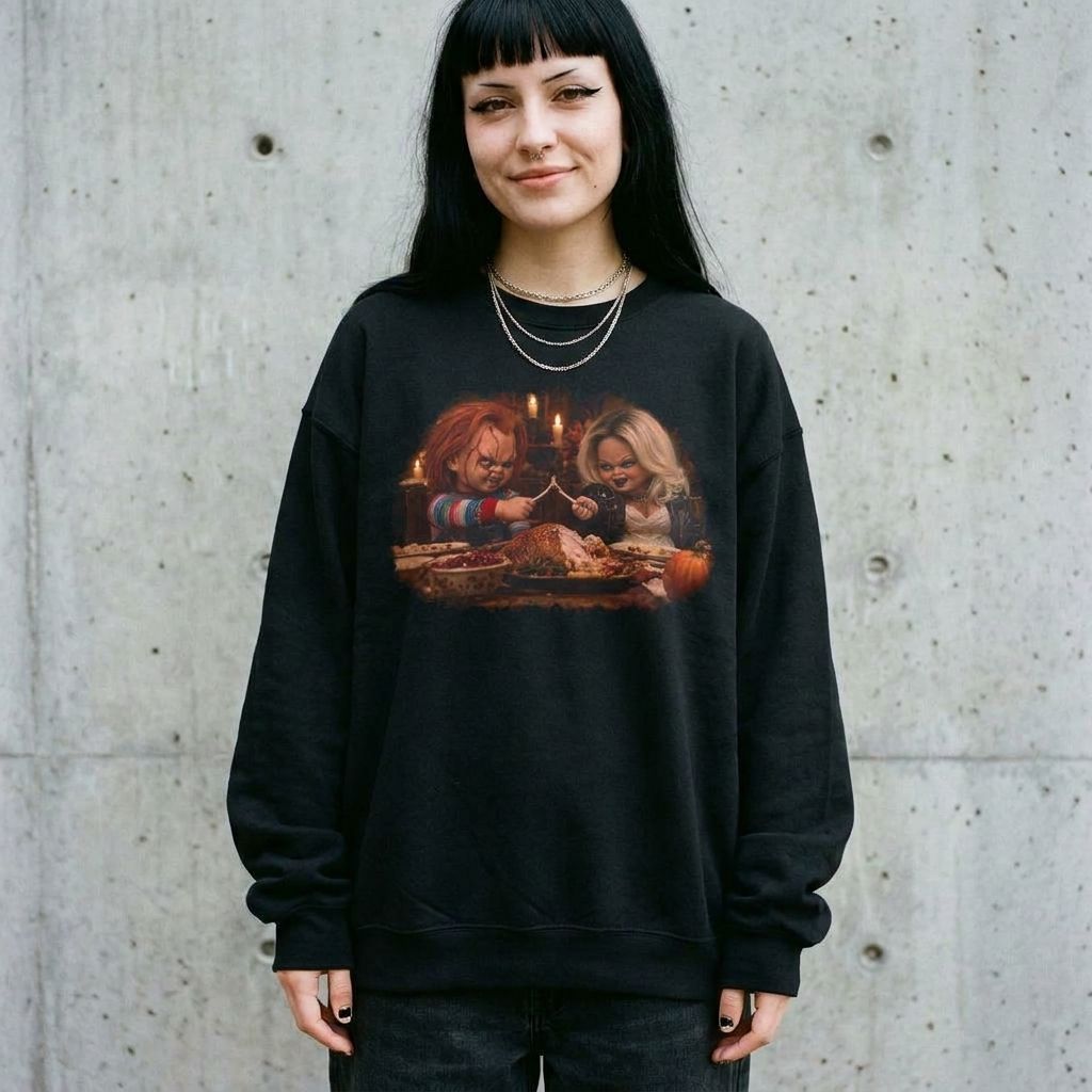 Model wearing the Chucky & Tiffany Thanksgiving wishbone sweatshirt in Black against a cement wall