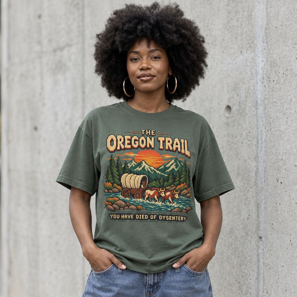 Model wearing Oregon Trail Vintage Graphic Tee against a cement wall