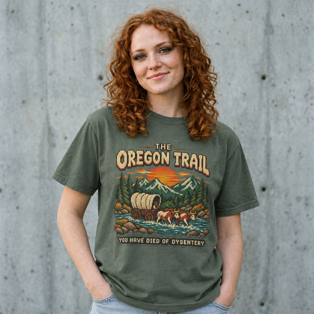 Woman wearing the Oregon Trail vintage graphic tee against a cement wall