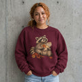 Woman wearing the cute raccoon fall crewneck sweatshirt against a cement wall