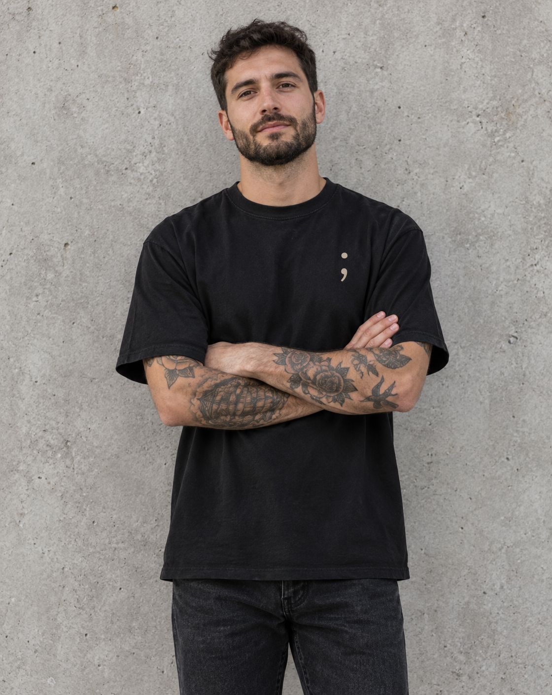 Model wearing the black You Are More Than Your Hardest Day t-shirt, front view with small semicolon