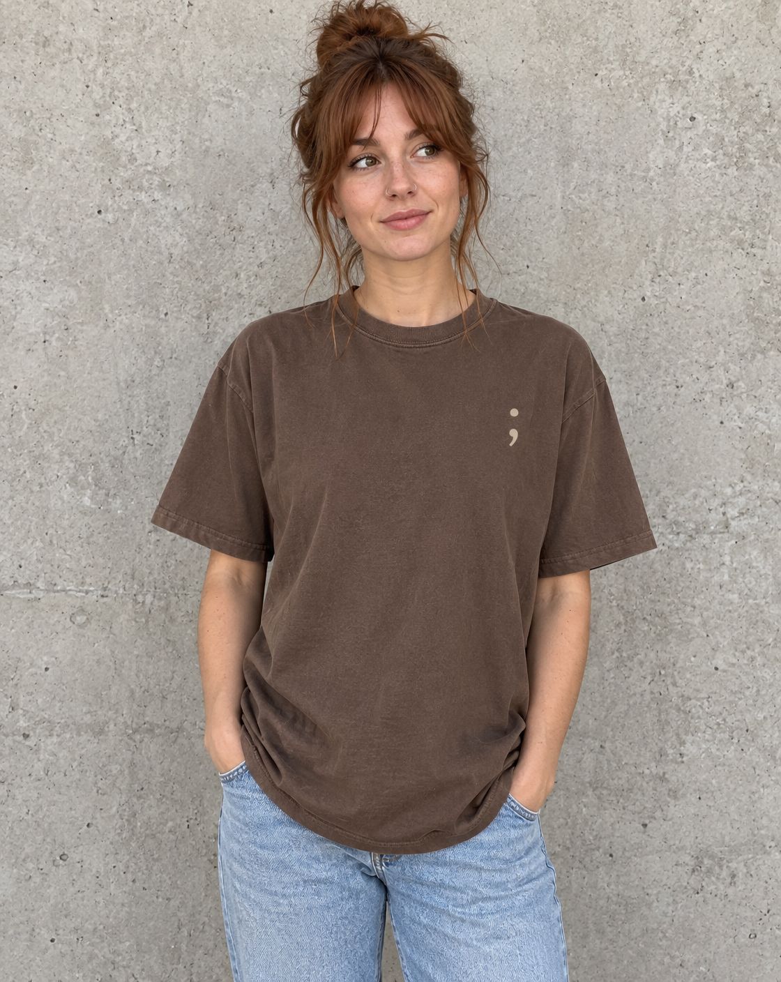 Model wearing the espresso Stay for Tomorrow t-shirt, front view with small semicolon