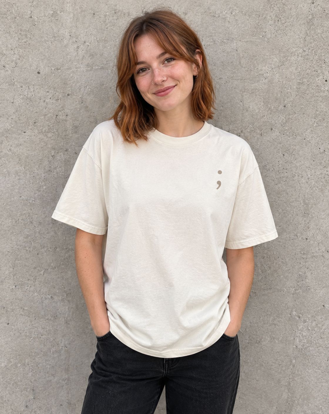 Model wearing the ivory I'm So Glad You're Here t-shirt, front view with small semicolon