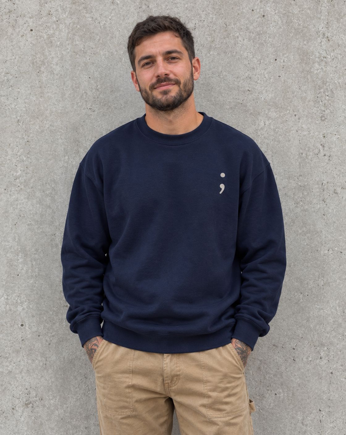 Model wearing the navy Keep Going crewneck sweatshirt, front view with small semicolon
