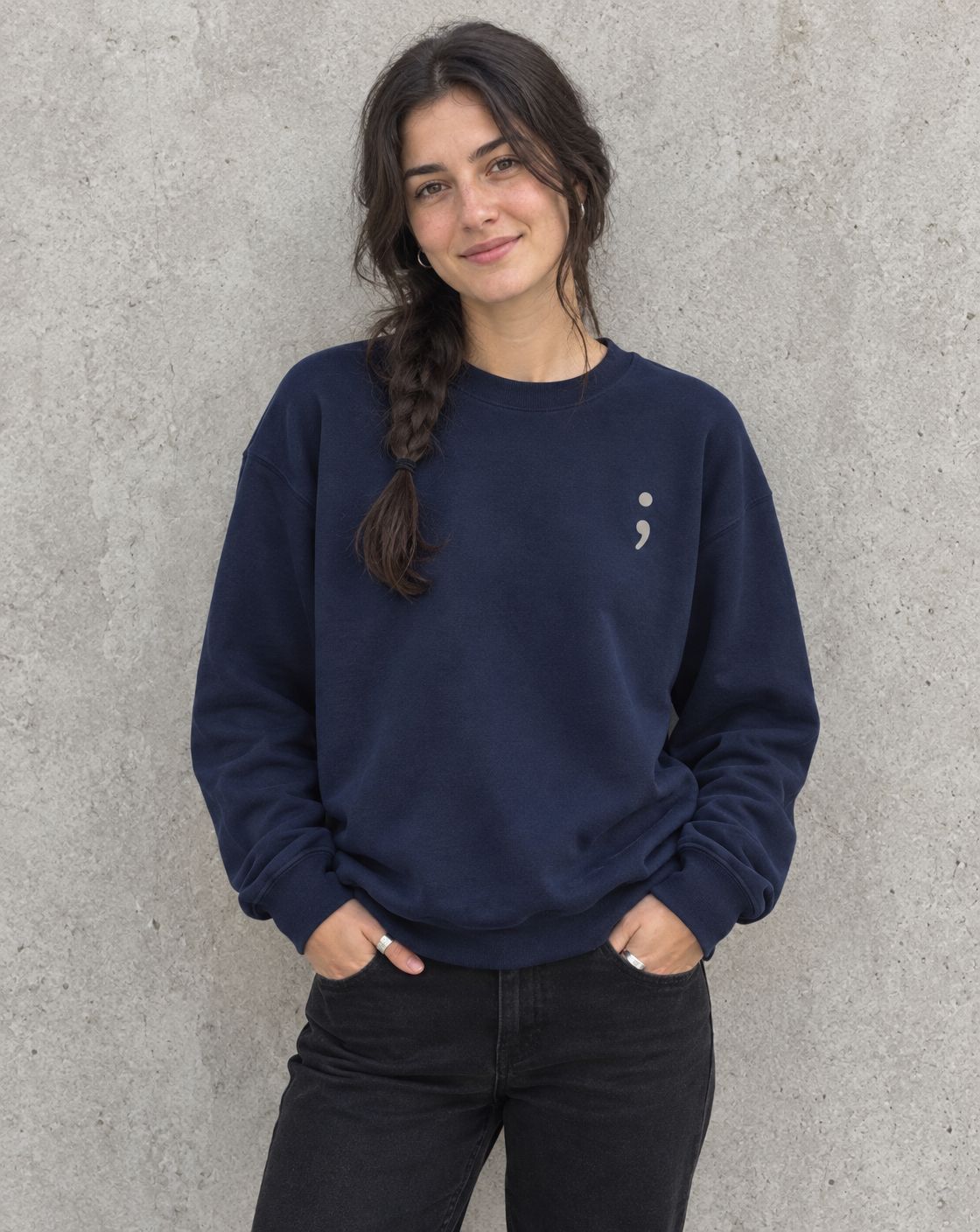 Model wearing the navy Be the Reason Someone Feels Less Alone crewneck sweatshirt, front view with small semicolon