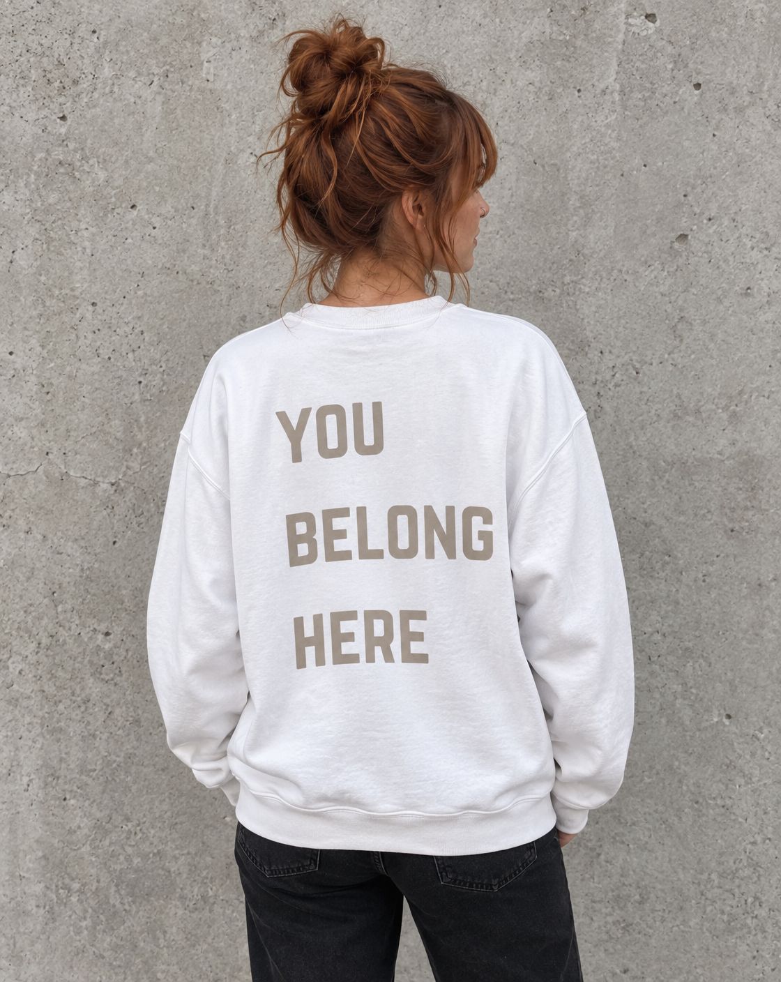 Model wearing the white You Belong Here suicide awareness crewneck sweatshirt, back view