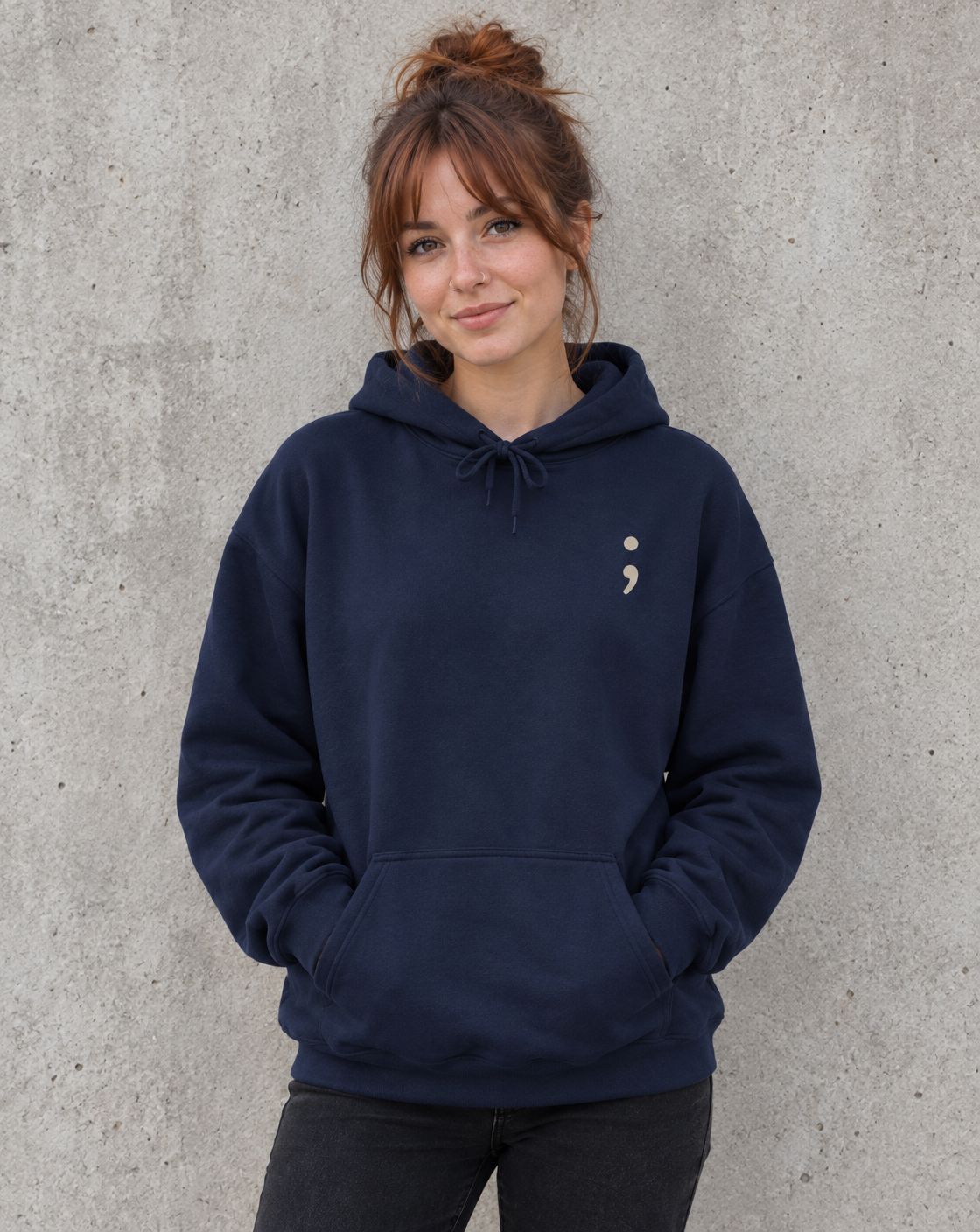 Model wearing the navy Be the Reason Someone Feels Less Alone pullover hoodie, front view with small semicolon