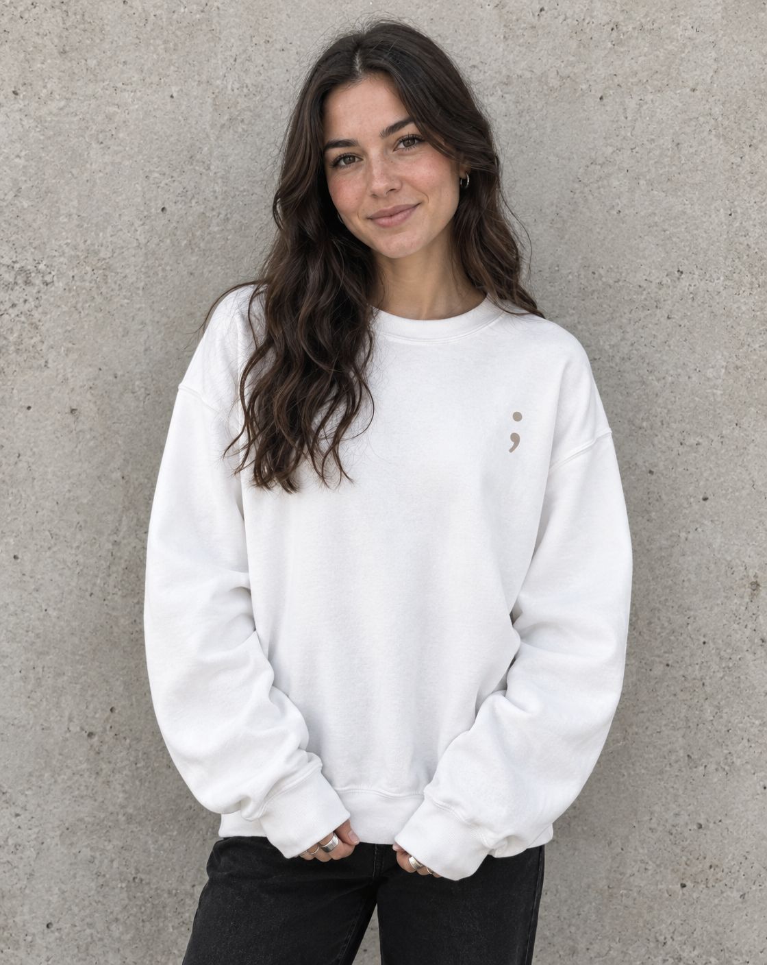 Model wearing the white I'm So Glad You're Here crewneck sweatshirt, front view with small semicolon