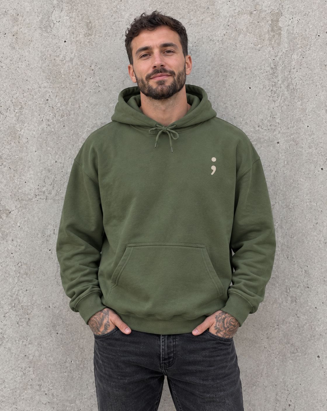 Model wearing the military green To the Person Behind Me, You Matter pullover hoodie, front view with small semicolon