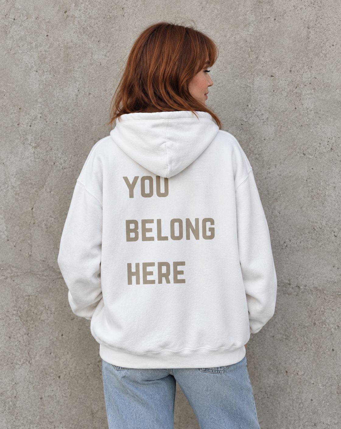 Model wearing the white You Belong Here suicide awareness pullover hoodie, back view
