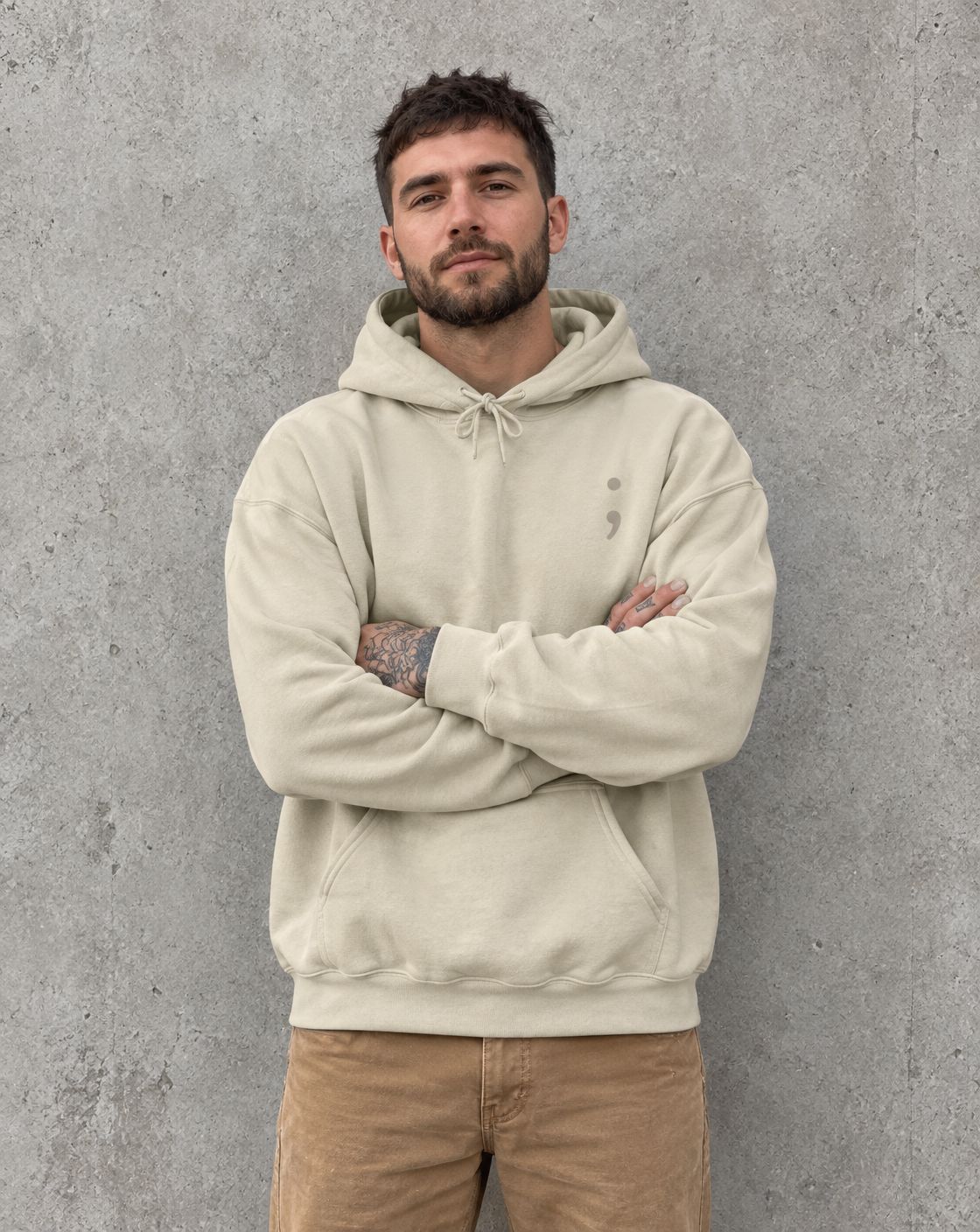 Model wearing the sand I Got Your Six pullover hoodie, front view with small semicolon