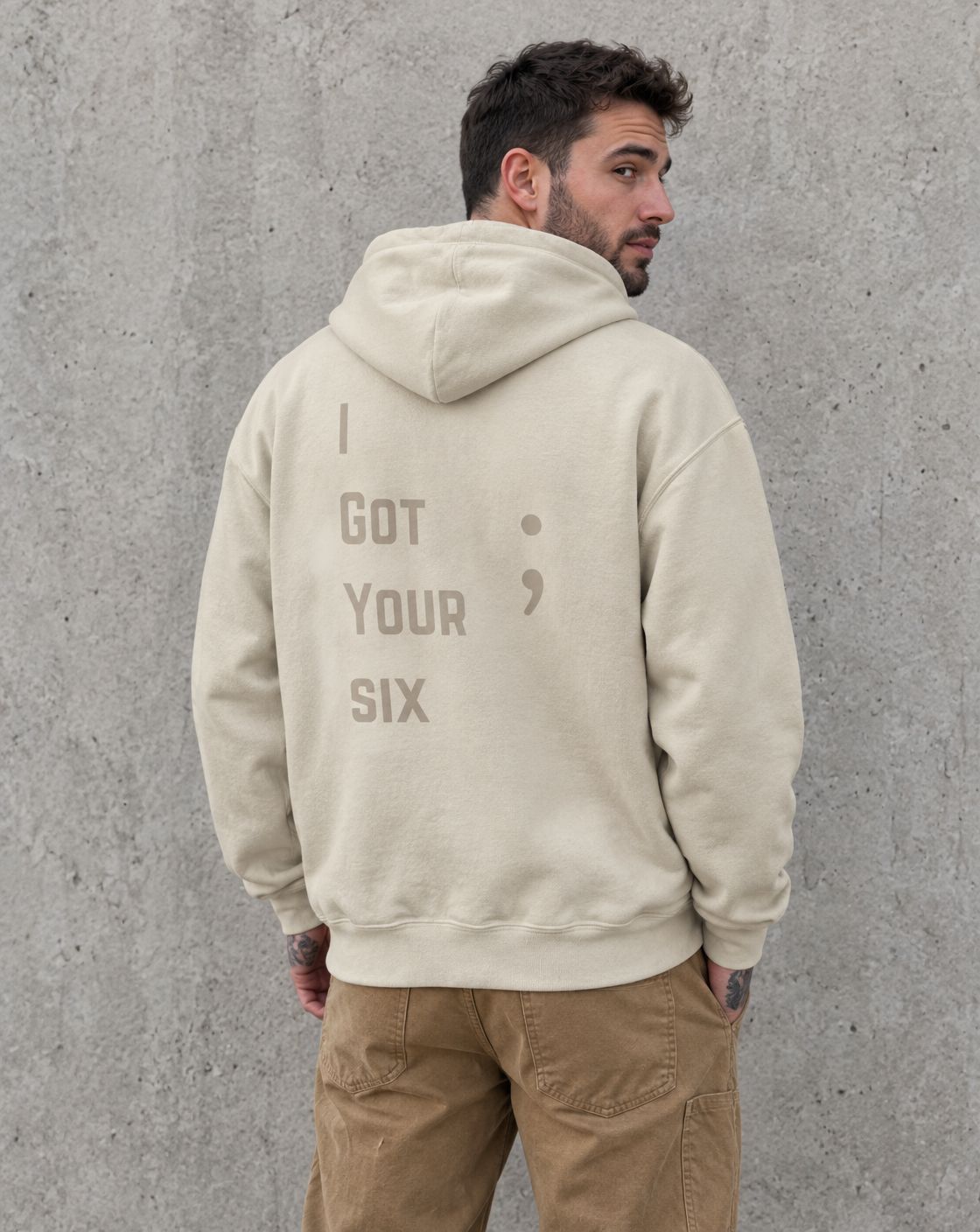 Model wearing the sand I Got Your Six veteran suicide awareness pullover hoodie, back view