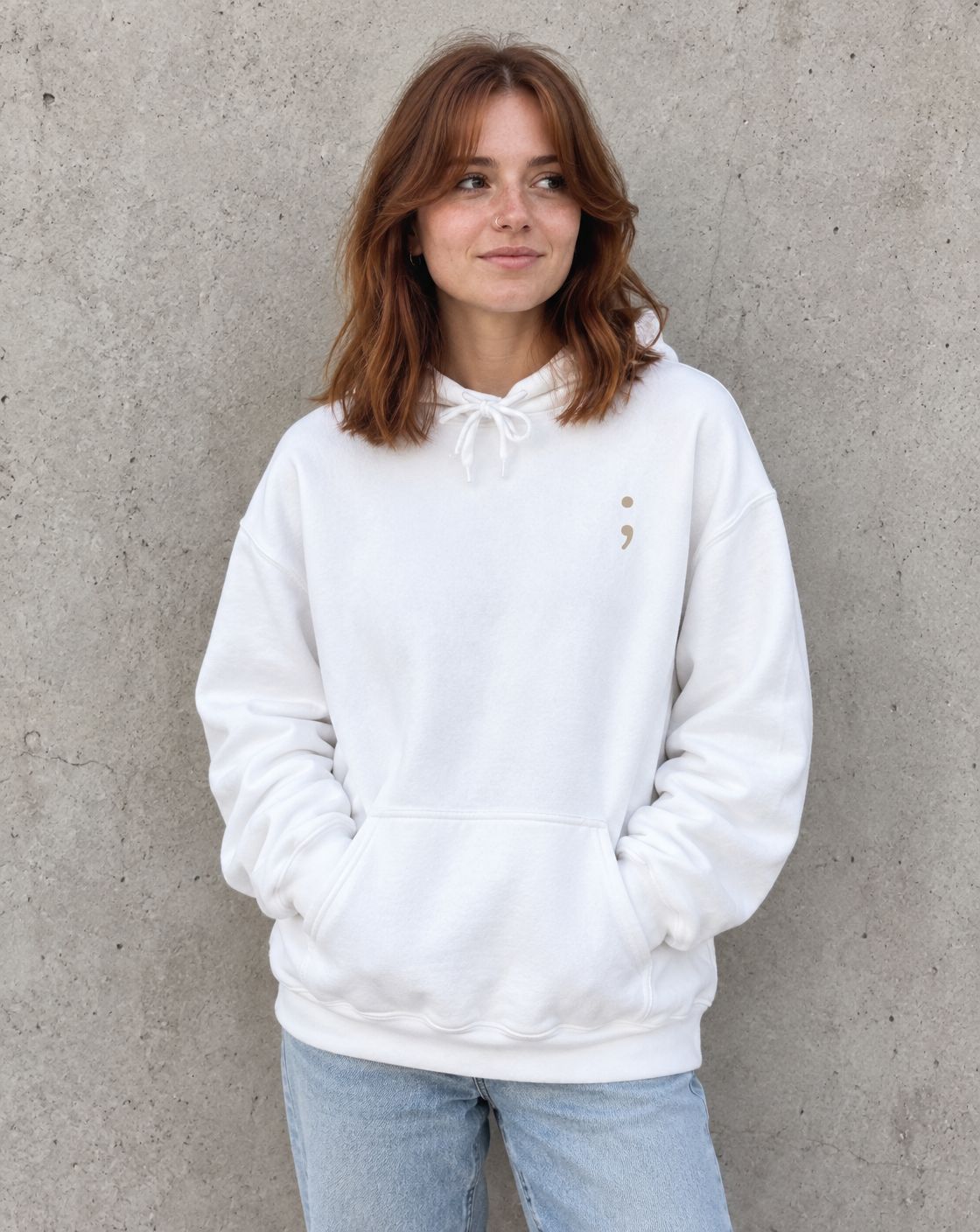 Model wearing the white You Belong Here pullover hoodie, front view with small semicolon