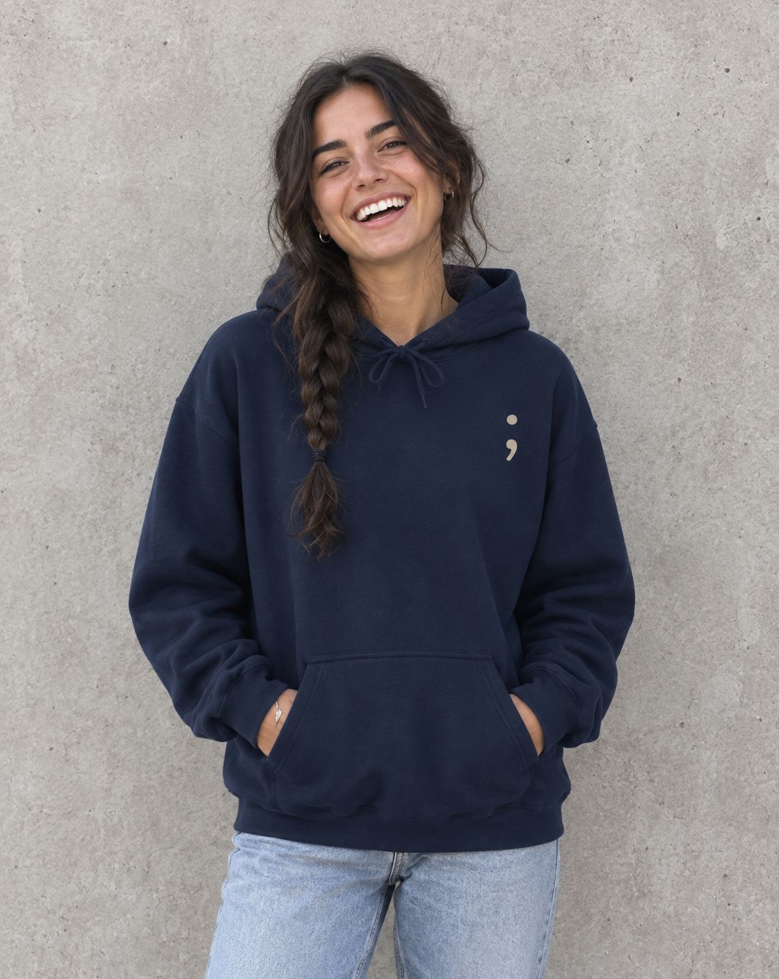 Model wearing the navy Keep Going pullover hoodie, front view with small semicolon