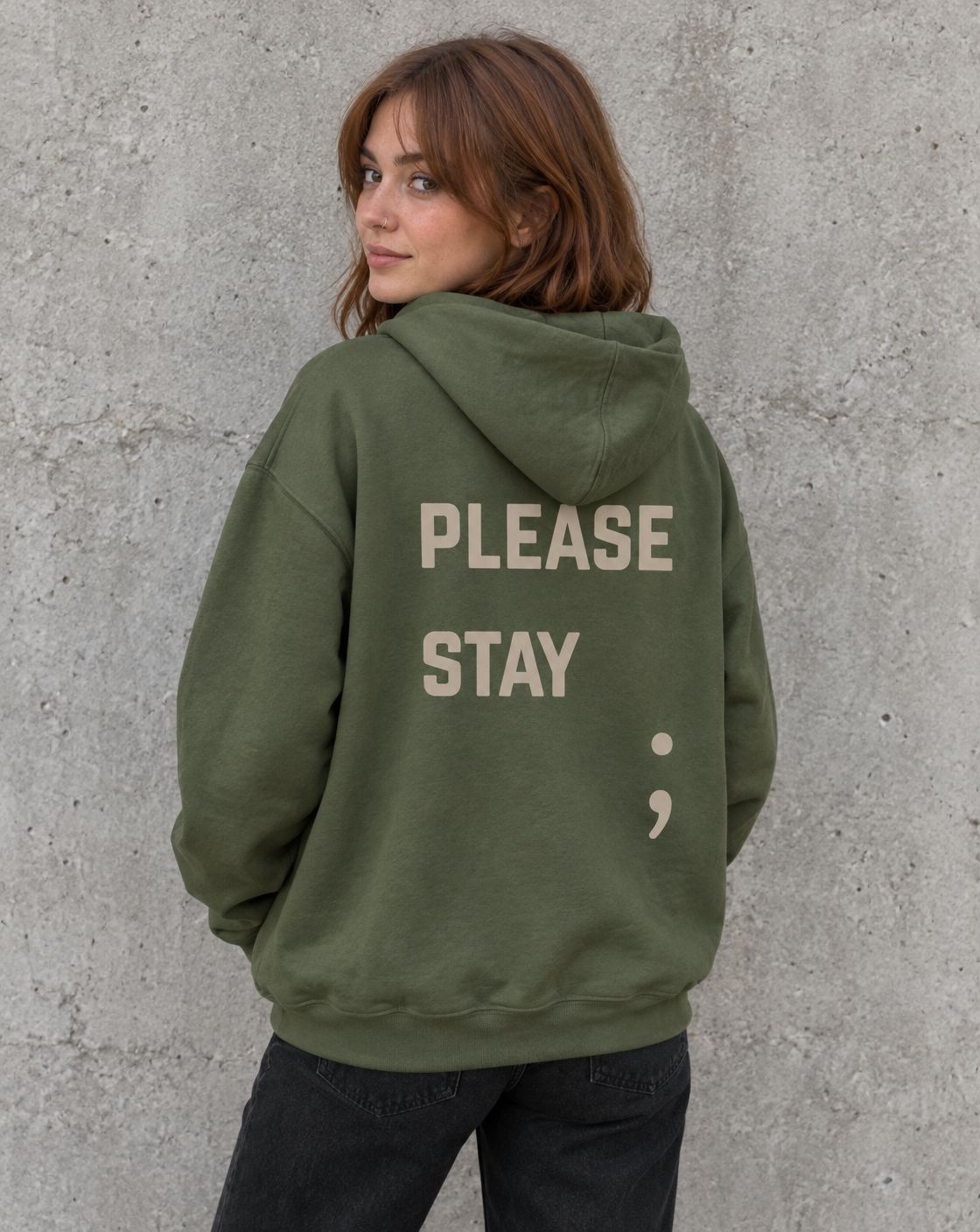 Model wearing the military green Please Stay; suicide awareness pullover hoodie, back view
