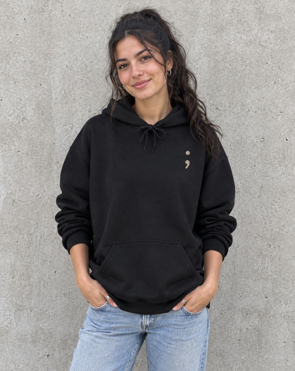 Model wearing the black You Matter. pullover hoodie, front view with small semicolon